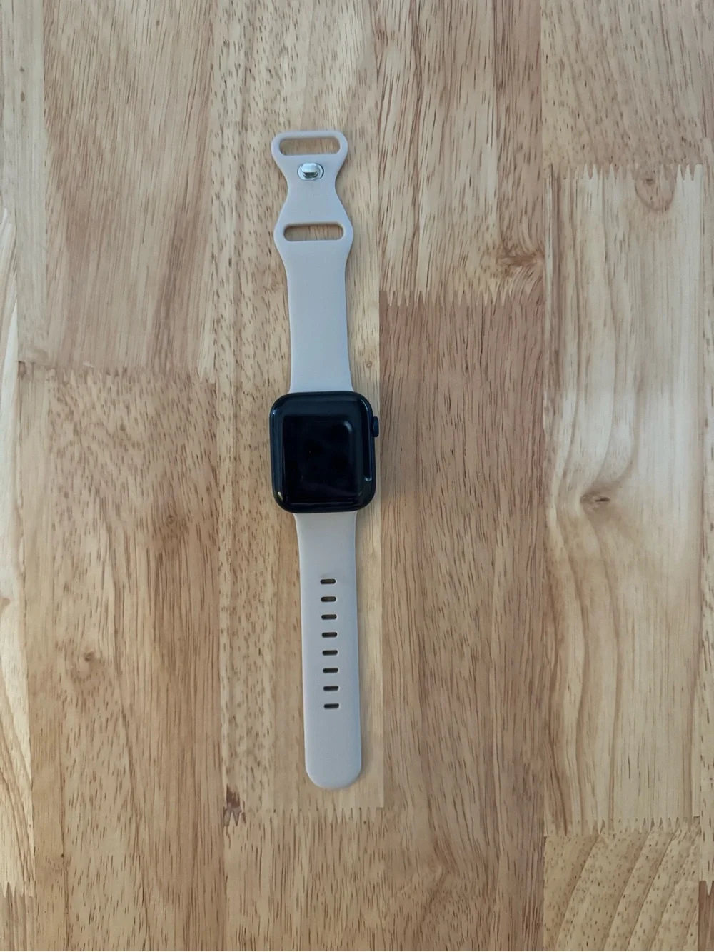 Apple Smartwatch with Light Beige Silicone Band and Black Face